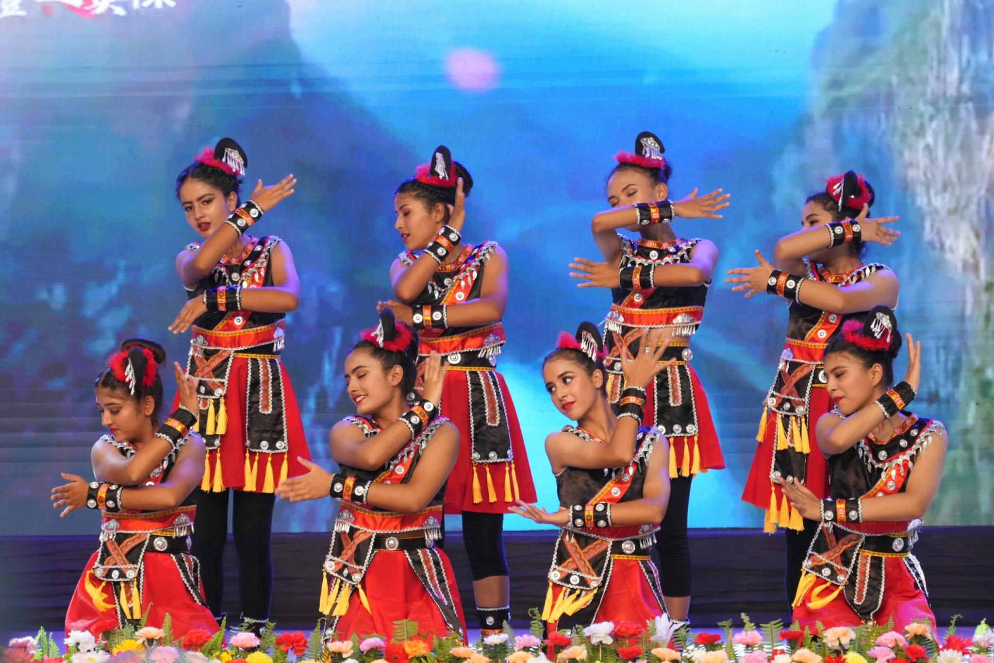 Performers in traditional Nepali dress on stage during a Nepal–China cultural exchange programme